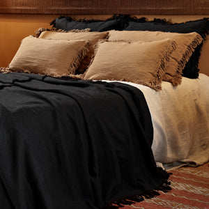 Colcha de lino de color negro con cojines terracota